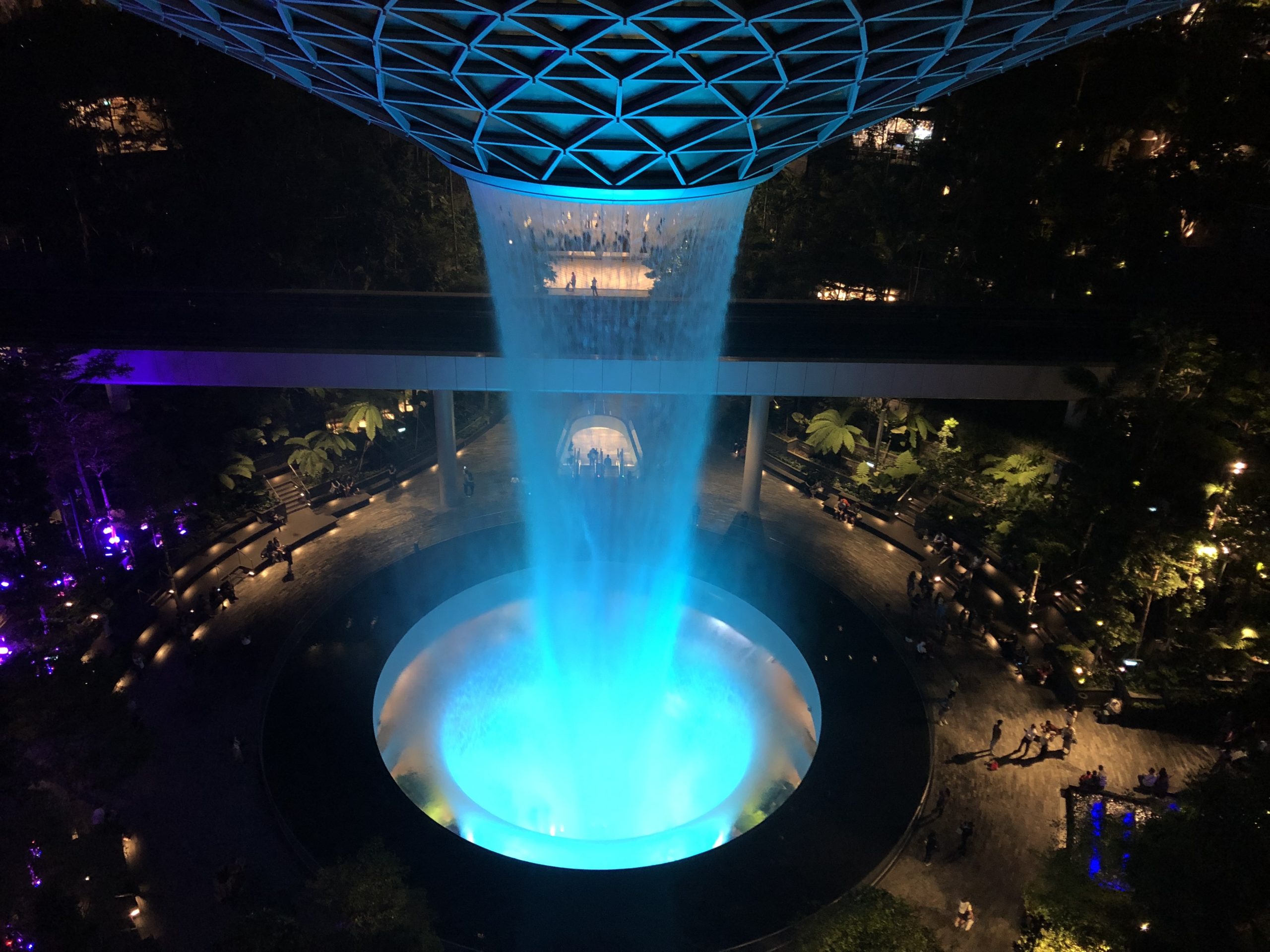 A man-made waterfall lit up in blue